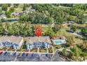 Aerial view of condo building with a pool, surrounded by trees and a golf course at 4430 Eastport Blvd. # L15, Little River, SC 29566