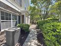Landscaped walkway leading to a townhome entrance with brick accents and lush greenery at 514 Hay Hill Ln. # C, Myrtle Beach, SC 29579