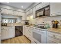 Bright kitchen featuring white cabinetry, granite countertops, and stainless steel appliances at 5507 N Ocean Blvd. # 105, Myrtle Beach, SC 29577