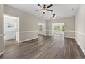 Spacious living room with wood-look flooring, neutral walls, and two ceiling fans at 561 Bucks Trail, Longs, SC 29568