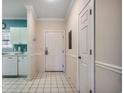 Inviting hallway with white tile floors and trim, leading to the kitchen at 5825 Catalina Dr. # 1132, North Myrtle Beach, SC 29582