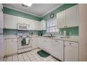 Bright kitchen featuring white cabinetry, appliances, and a garden view at 5825 Catalina Dr. # 1132, North Myrtle Beach, SC 29582