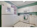 Charming kitchen with white cabinetry and appliances at 5825 Catalina Dr. # 1132, North Myrtle Beach, SC 29582