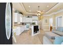Bright, open kitchen with white cabinetry, tiled floors, and island, connecting to the living area at 6001-1783 S Kings Hwy., Myrtle Beach, SC 29575