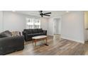 Bright living room features stylish wood-look flooring, modern ceiling fan, and neutral decor at 6001-Mh409 S Kings Hwy., Myrtle Beach, SC 29575