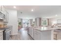 Open-concept kitchen featuring granite countertops and a view to living room at 706 Chazen Way, Longs, SC 29568