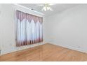 Bedroom with hardwood floors, a ceiling fan, and a large window with sheer curtains at 736 Lalton Dr., Conway, SC 29526