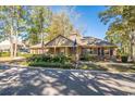 Community building exterior with mature landscaping, flags, and ample parking, set against a backdrop of tall trees at 830 44Th Ave. N # B4, Myrtle Beach, SC 29577