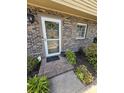 Welcoming front entrance with a glass screen door, brick walkway, and decorative landscaping at 830 44Th Ave. N # B4, Myrtle Beach, SC 29577