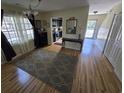 Inviting living area with hardwood floors, natural light from windows, and an open view into the kitchen at 830 44Th Ave. N # B4, Myrtle Beach, SC 29577