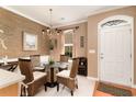 Inviting dining room with stylish chandelier, glass table, and a decorative accent wall at 830 Howard Ave. # D, Myrtle Beach, SC 29577