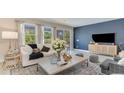 Cozy living room features lots of natural light and modern decor with a decorative blue accent wall at 880 Ireland Dr., Longs, SC 29568