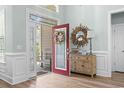 Inviting foyer with hardwood floors and a decorative mirror and console table at 929 Tidewater Dr., North Myrtle Beach, SC 29582