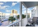 Balcony view overlooking the pool area and nearby buildings, with a comfortable chair at 9581 Shore Dr. # 223, Myrtle Beach, SC 29572