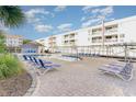 Relaxing pool area with lounge chairs for residents and guests, surrounded by trees and landscaping at 9581 Shore Dr. # 223, Myrtle Beach, SC 29572