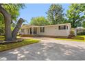 Well-maintained home featuring a long driveway, covered porch, and mature landscaping at 976 South Marlin Circle, Murrells Inlet, SC 29576