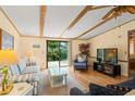 Comfortable living room with exposed beam ceiling, sliding glass doors to backyard, and stylish furnishings at 976 South Marlin Circle, Murrells Inlet, SC 29576
