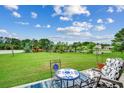 Spacious backyard overlooking a serene lake, featuring a seating area and lush green grass at 1001 Harvest View Ave., Conway, SC 29527
