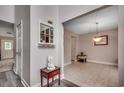 Hallway with wood-look floors leads to dining room with tile flooring and an adjacent doorway at 1001 Harvest View Ave., Conway, SC 29527
