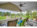 Relaxing screened porch with comfortable seating, a ceiling fan, and scenic views of the lake at 1001 Harvest View Ave., Conway, SC 29527