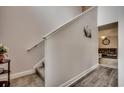 Bright staircase featuring neutral walls, carpeted steps, and white trim. It leads to the upper level at 1001 Harvest View Ave., Conway, SC 29527
