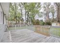 Spacious wooden deck in backyard, surrounded by lush trees and serene outdoor space at 1028 1St Ave. S, North Myrtle Beach, SC 29582