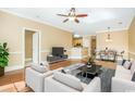 Open concept living room, dining, and kitchen area with hardwood floors and modern decor at 106 Birch N Coppice Dr. # 2, Surfside Beach, SC 29575