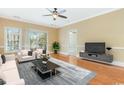Bright living room with a ceiling fan, plush sofa set, and hardwood floors at 106 Birch N Coppice Dr. # 2, Surfside Beach, SC 29575