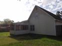 Back exterior view of the home featuring a screened-in porch at 108 Pickerel Blvd., Longs, SC 29568