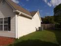 Exterior side view of home featuring vinyl siding, dark shutters and a green lawn at 108 Pickerel Blvd., Longs, SC 29568