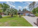 Charming brick home with an attached garage, long driveway, and green lawn at 112 Boxwood Ln., Conway, SC 29526