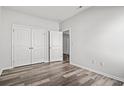 A simple bedroom space showcasing a closet with double doors and stylish wood-look flooring at 116 Old Chimney Ln, Conway, SC 29526