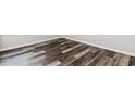An angled view showcasing the stylish, dark-toned wood flooring that adds a modern touch to the room at 116 Old Chimney Ln, Conway, SC 29526
