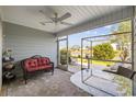 Relaxing screened porch with fan overlooking a lovely view, complete with comfortable seating and a table at 136 Queens Cove Place # B, Myrtle Beach, SC 29579