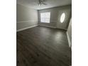 Bright living room featuring modern wood-look flooring, fresh paint, and ample natural light at 1432 Highway 544 # F1, Conway, SC 29526