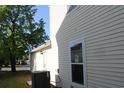 A side view of the home, showcasing the vinyl siding, window, back door, and utility box at 148 Weeping Willow Dr., Myrtle Beach, SC 29579