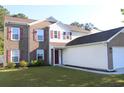 Well-maintained two-story home with brick and vinyl siding, eye-catching red shutters, and lush green lawn at 148 Weeping Willow Dr., Myrtle Beach, SC 29579