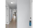 Long hallway with neutral tile flooring leads to a screened in porch with backyard views at 1890 Colony Dr. # 17S, Myrtle Beach, SC 29575