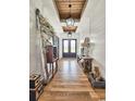 Inviting entryway with wood floors, shiplap walls, and stylish light fixtures at 2300 Tansy Rd., Loris, SC 29569