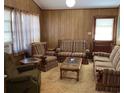 Comfortable living room featuring paneled walls, a coffee table, and matching striped sofas and chairs at 317 29Th Ave. N, North Myrtle Beach, SC 29582