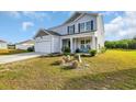 Charming two-story home with a well-maintained lawn and an attached two-car garage at 417 Spruce Pine Way, Conway, SC 29526