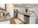 Modern kitchen featuring granite countertops, stainless steel appliances, and wooden floors at 4488 East Coast Ln., Shallotte, NC 28470