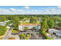 Aerial view of a condo building with lush landscaping, golf course, and ample parking at 4567 Eastport Blvd. # 3P, Little River, SC 29566