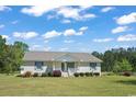 A beautiful single-story home with a classic brick facade and a cozy, inviting front porch at 4684 Bluff Rd., Mullins, SC 29574