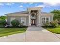 Charming one-story home boasts a classic facade with a large, arched entryway and manicured landscaping at 482 Pomo Dr., Myrtle Beach, SC 29579