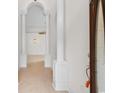 Bright hallway featuring elegant columns, tile flooring, and a view of a decorative light fixture at 482 Pomo Dr., Myrtle Beach, SC 29579