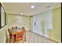 Cozy dining area featuring a table with four chairs, tile flooring, and neutral wall colors at 504 N Ocean Blvd. # 1810, Myrtle Beach, SC 29577