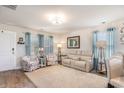 Bright living room with cozy seating, large windows, and elegant decor at 509 Wildfire Ct., Longs, SC 29568