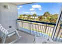 Balcony with ocean views, white rocking chairs, and blue railings, providing a relaxing outdoor space at 5511 N Ocean Blvd. # 209, Myrtle Beach, SC 29577