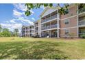 Exterior shot of three-story condos showcasing serene views from screened patios and overlooking lush green space at 619 Waterway Village Blvd. # 7C, Myrtle Beach, SC 29579